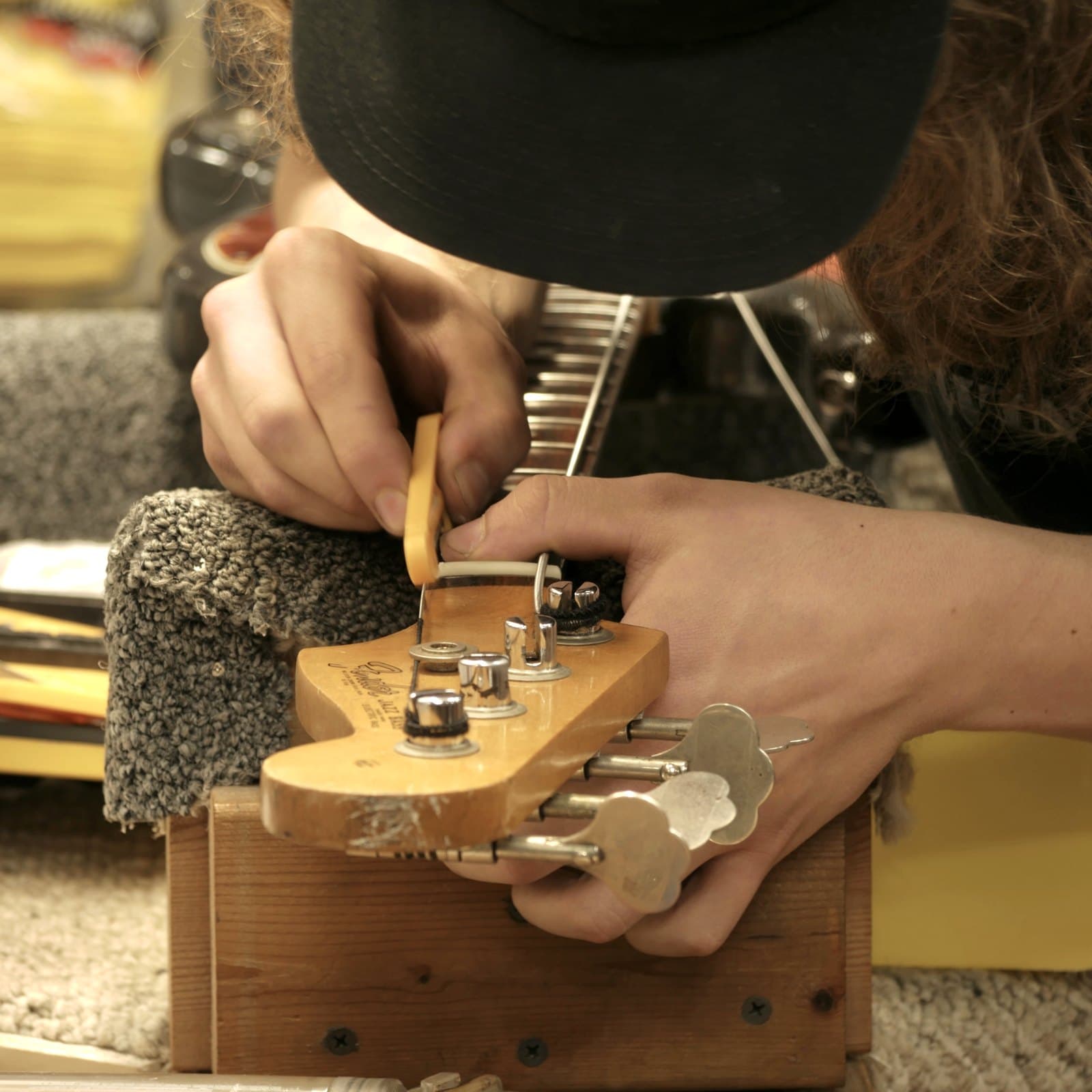 Shaping a headstock by hand, file and wood chips