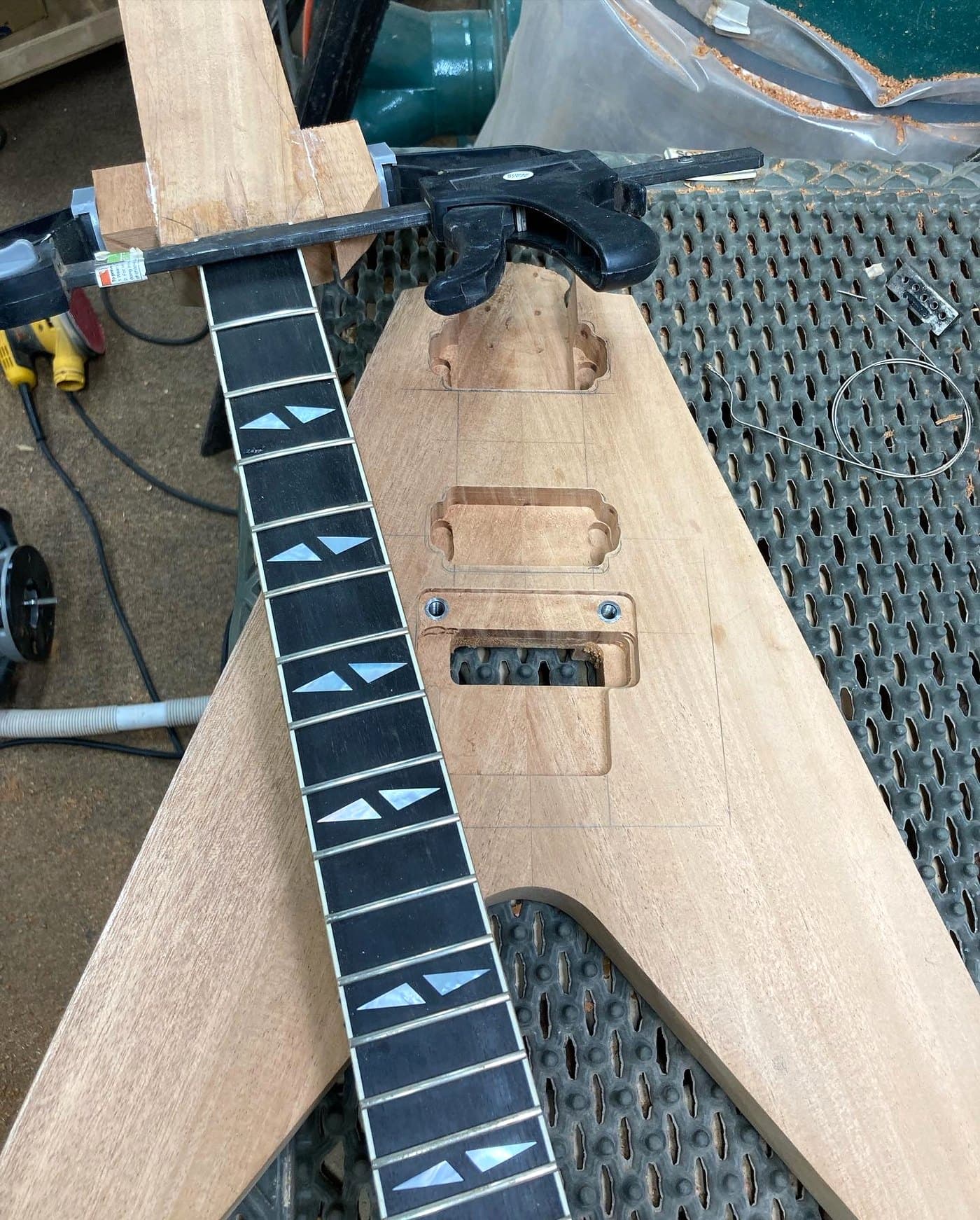 V neck on the bench, fretboard inlaid, body still raw