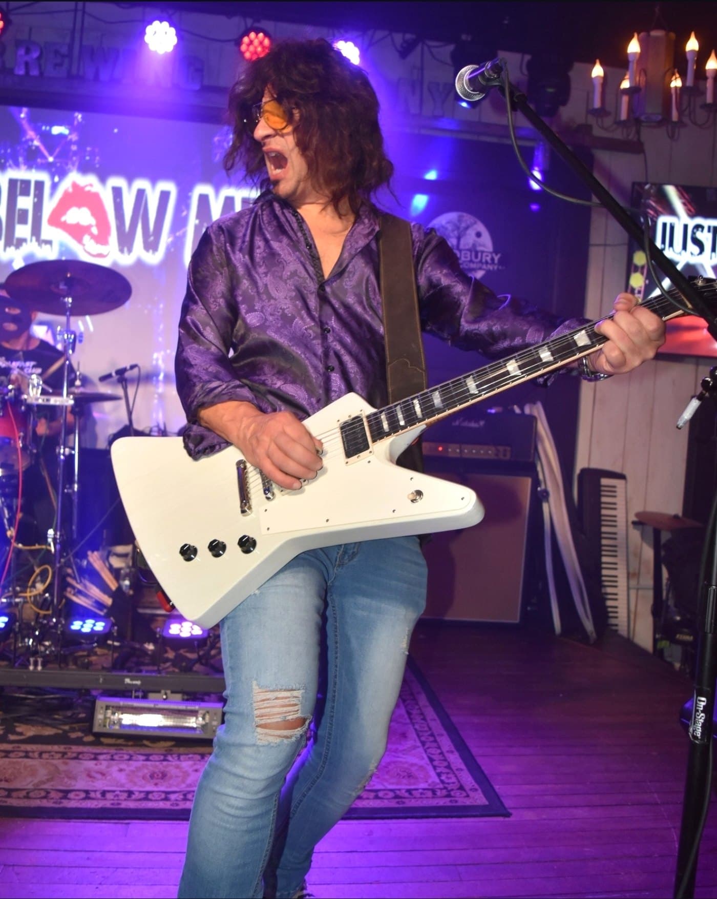 Chris Tatalias on stage mid-song, playing one of his own builds